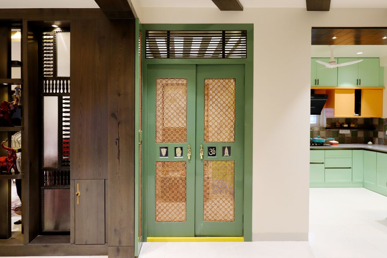 Crafting Captivating Headlines: Your awesome post title goes here Stylish green doorway featuring intricate lattice designs, leading to a brightly lit modern kitchen.